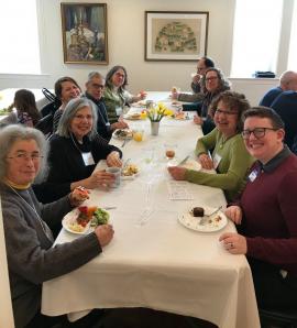 Rabbi Lily Solochek and synagogue members seated at table for a meal