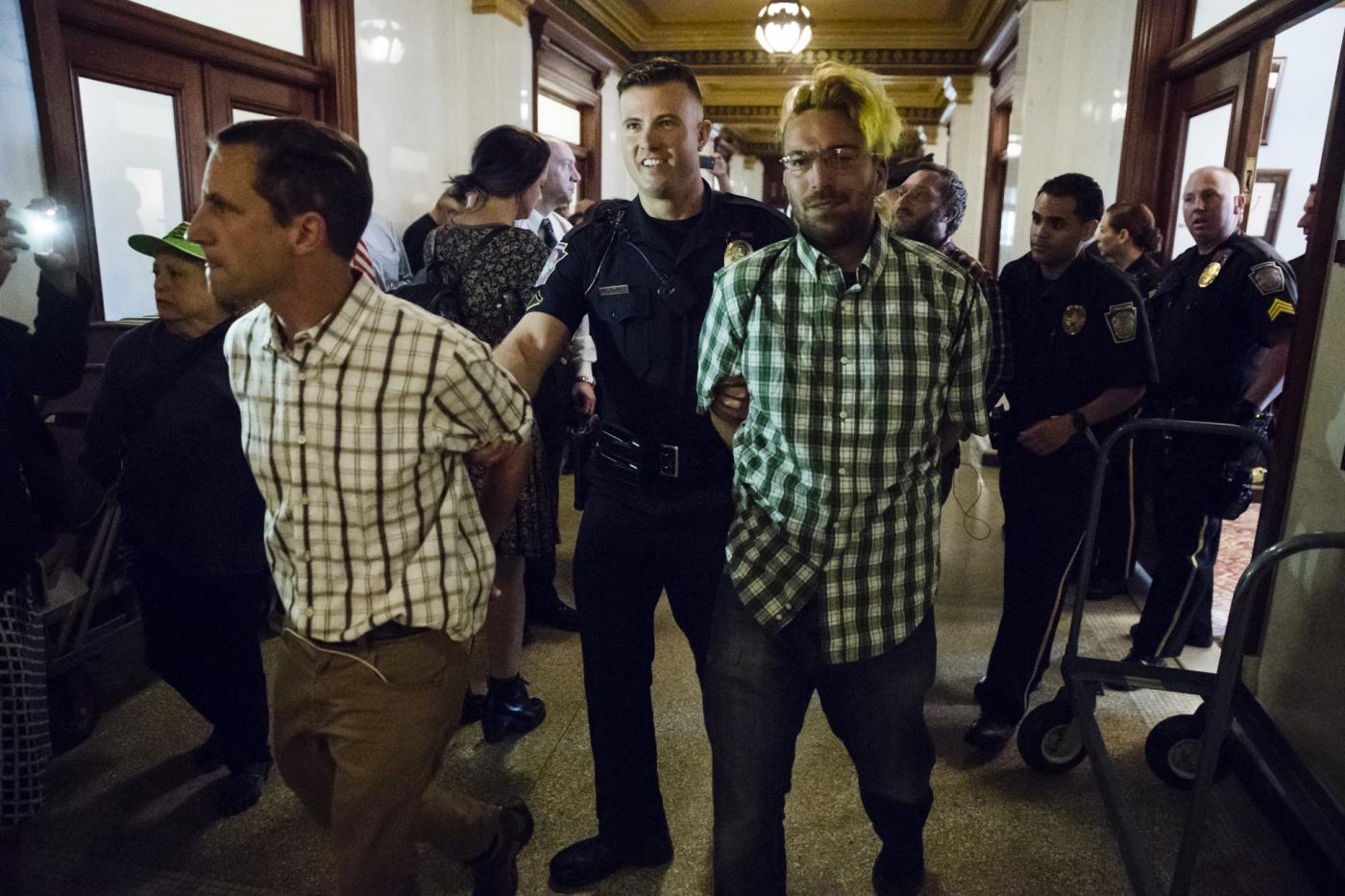 Gift ban advocates getting arrested by state Capitol police at one of their 2017 protests