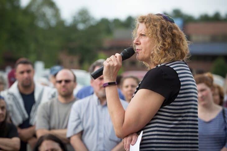 Rabbi Barara Penzner speaks at an outdoor protest