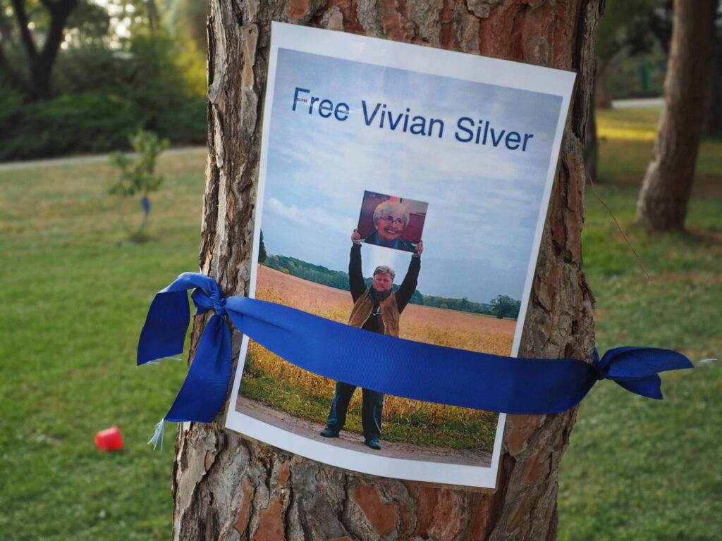 A missing sign for Vivian Silver, an activist who was presumed taken hostage but later identified as murdered on Oct. 7